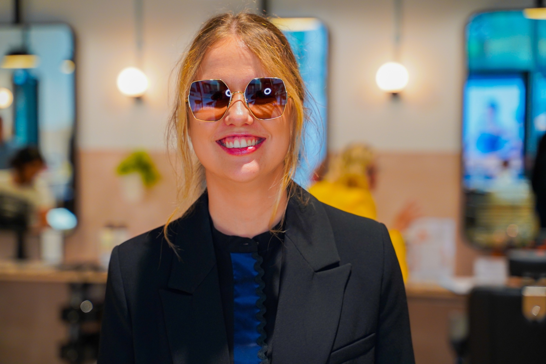 Woman modelling oversized sunglasses at a brand event