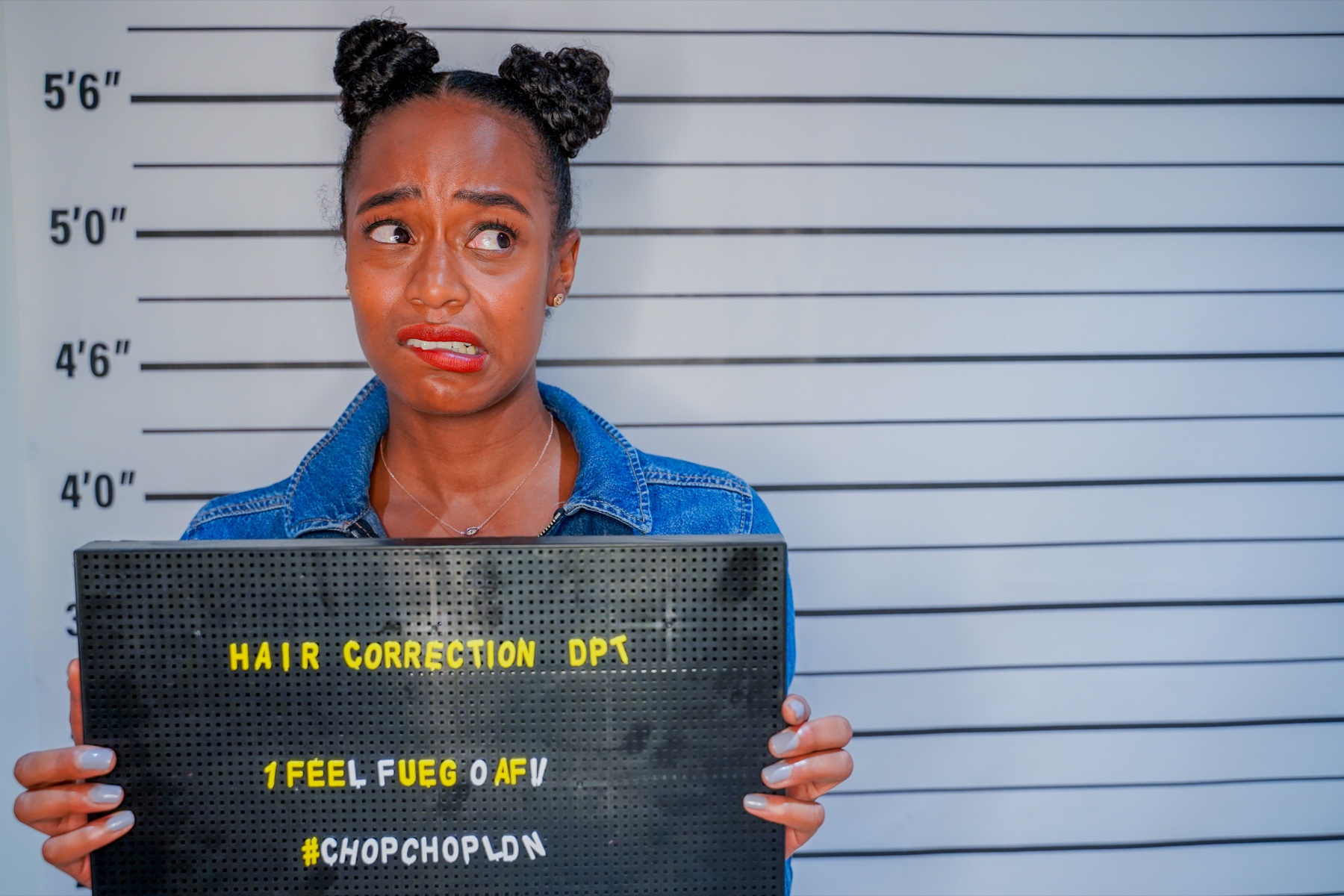Guest posing with a playful Chop Chop hair correction sign