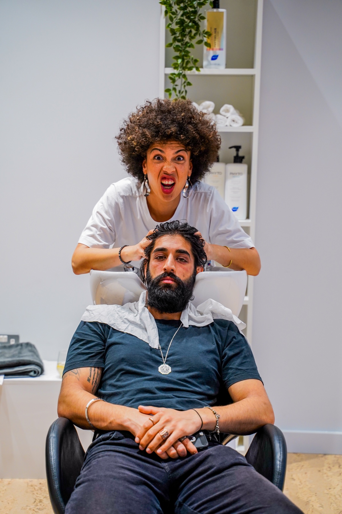 Hairdresser washing a guest's hair during the opening event