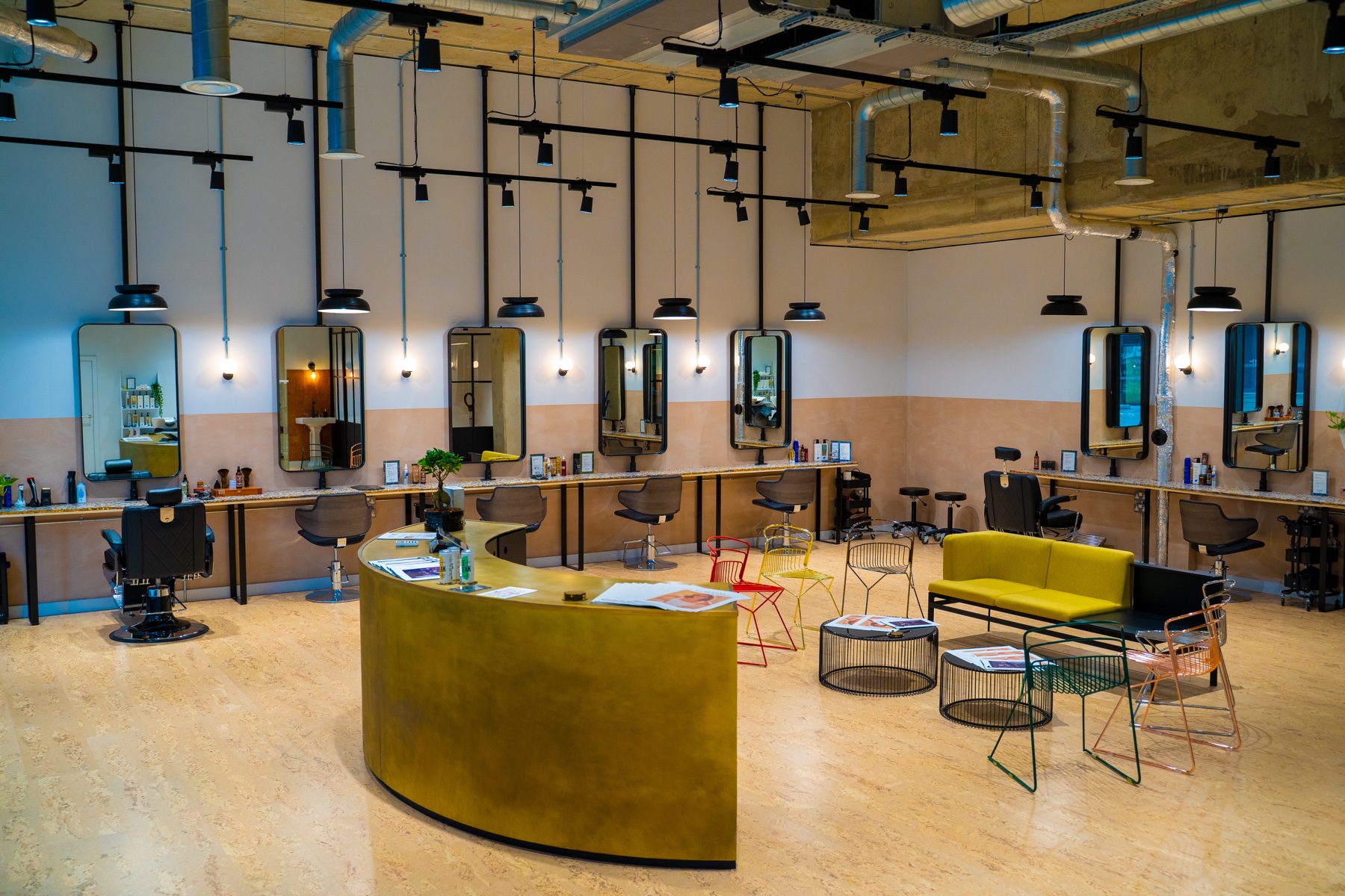 Wide commercial interior with reception, workstations and lounge seating