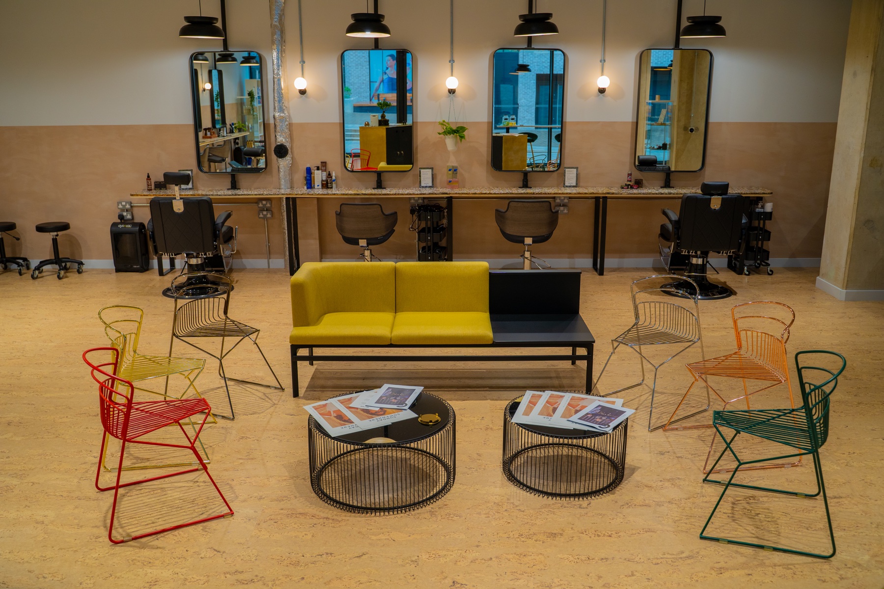 Commercial waiting area with colourful seating and mirrored workstations